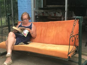 Midsection of woman sitting on chair