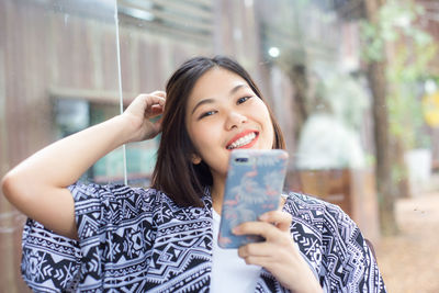 Portrait of woman using mobile phone