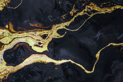 Texture of crude oil spill on sand beach from oil spill accident