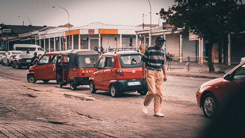 Cars on street against buildings in city