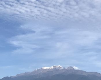 Low angle view of snowcapped mountains against sky