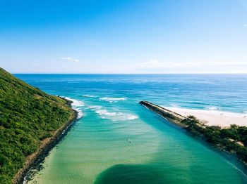 Scenic view of sea against blue sky