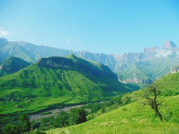 Scenic view of mountains against blue sky