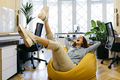 Woman sitting on chair in room