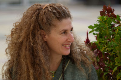 Close-up of smiling mature woman looking away