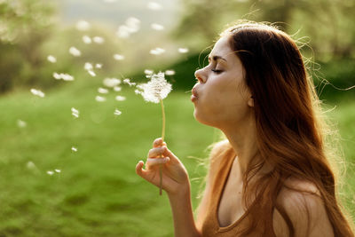 Young woman blowing bubbles