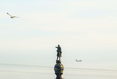 Low angle view of statue against sky