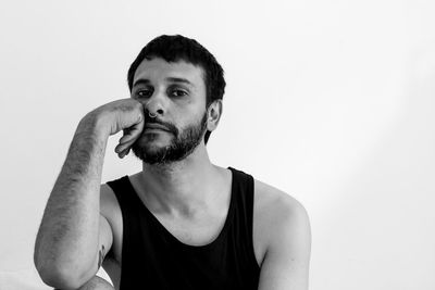 Portrait of young man against white background