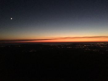 Aerial view of illuminated cityscape at sunset