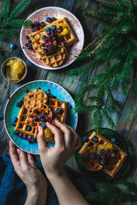 Cropped hand of woman with food on table