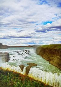 Scenic view of landscape against cloudy sky