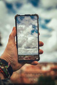 Close-up of hand holding mobile phone