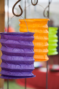 Close-up of paper bags hanging on hooks