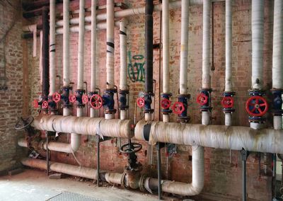 Pipes against brick wall in industry