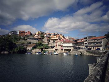 Townscape by sea against sky