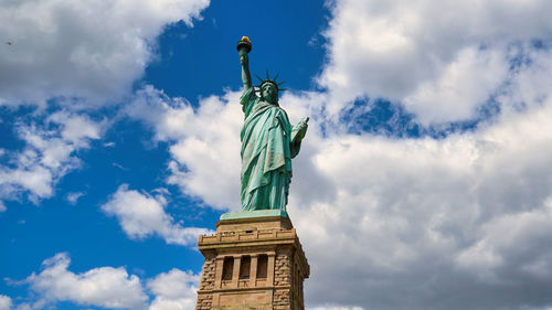 Low angle view of statue against cloudy sky