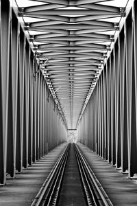 Empty railroad tracks on metallic bridge