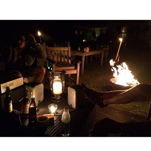 transfer print, flame, illuminated, burning, fire - natural phenomenon, night, heat - temperature, auto post production filter, glowing, table, candle, indoors, high angle view, light - natural phenomenon, lit, fire, chair, no people, built structure, dark