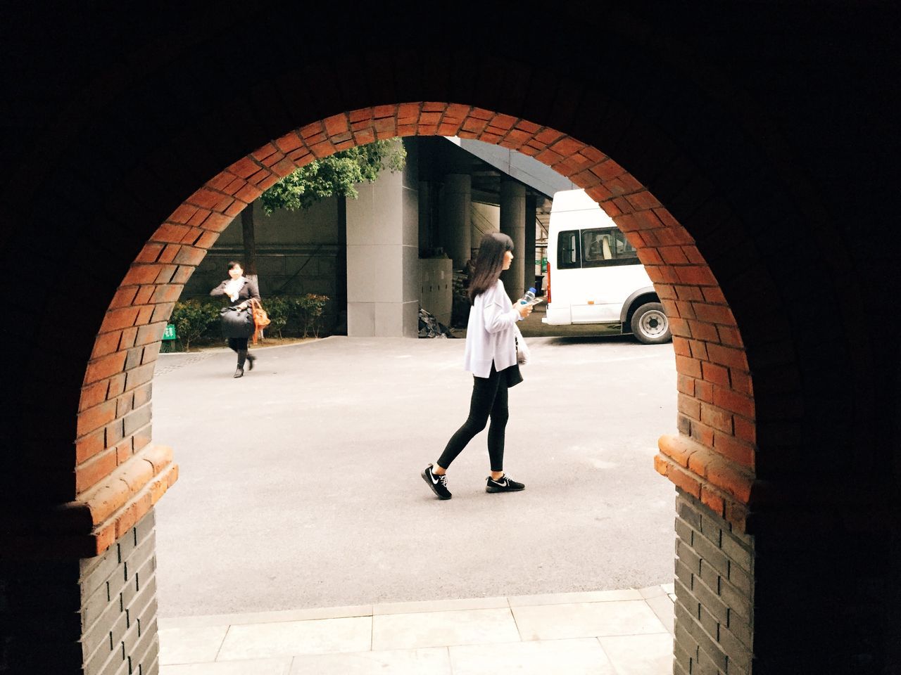 arch, full length, architecture, built structure, walking, lifestyles, rear view, men, archway, indoors, person, leisure activity, building exterior, casual clothing, tunnel, entrance, standing