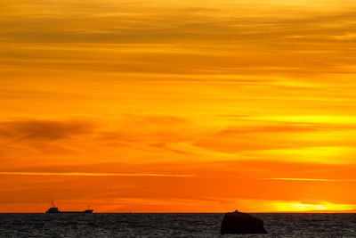 Scenic view of sea against orange sky