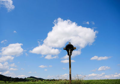 Low angle view of street light against blue sky