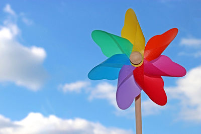 Low angle view of colorful pinwheel toy against sky