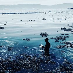 People on beach against sea