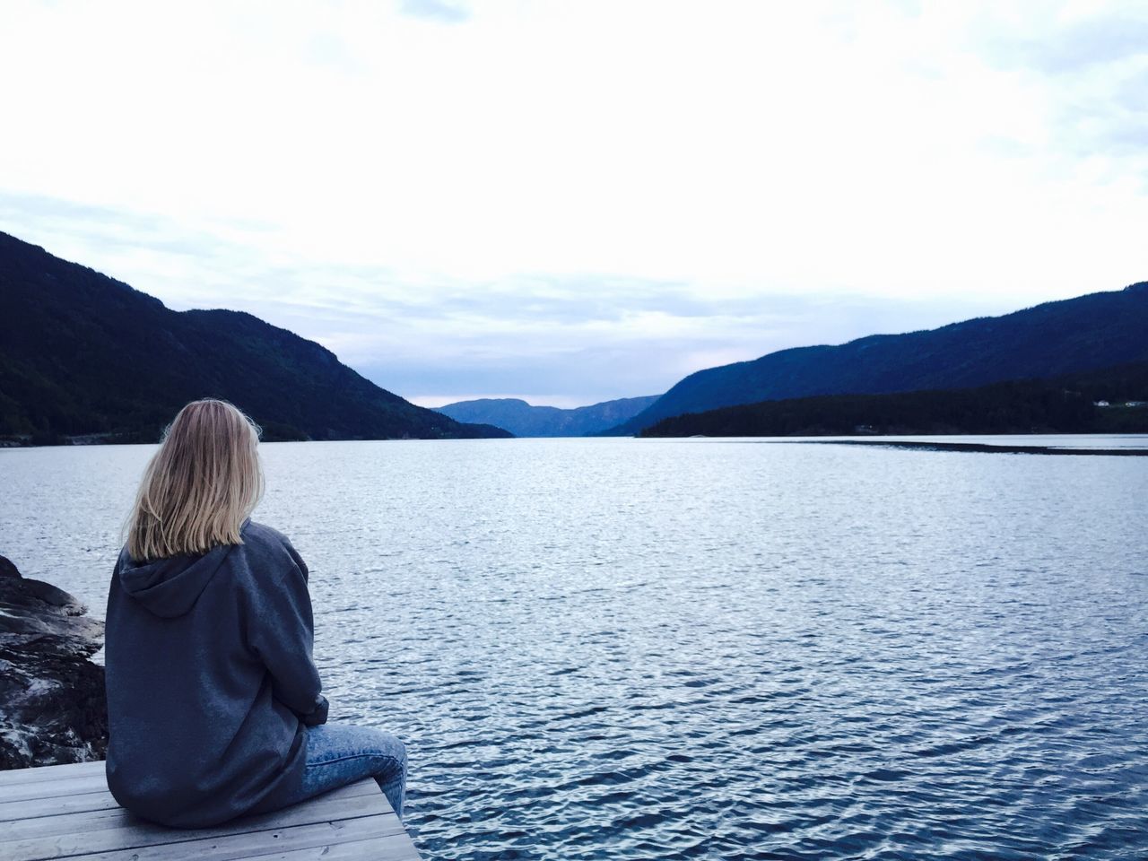 mountain, water, lifestyles, rear view, leisure activity, sky, mountain range, sitting, lake, scenics, tranquil scene, tranquility, casual clothing, looking at view, beauty in nature, nature, standing, men