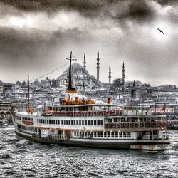 Boats in river with buildings in background