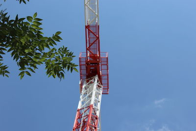 Low angle view of crane against sky