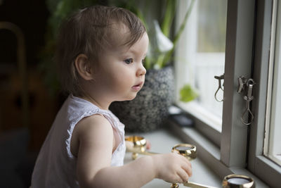 Girl looking through window