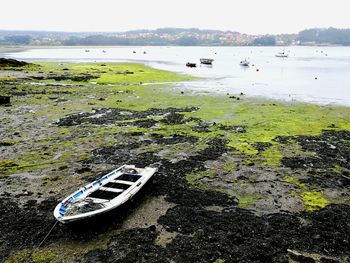 Boats in river at low tide