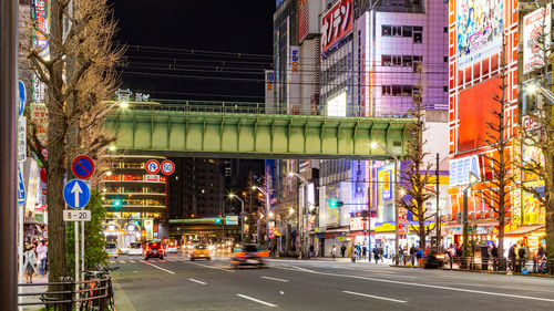 View of city street and buildings at night