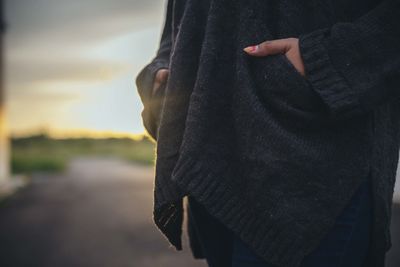 Midsection of woman standing against blurred background