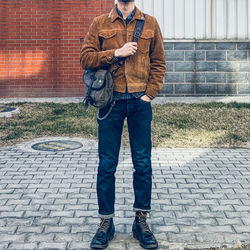 Full length of man standing on footpath