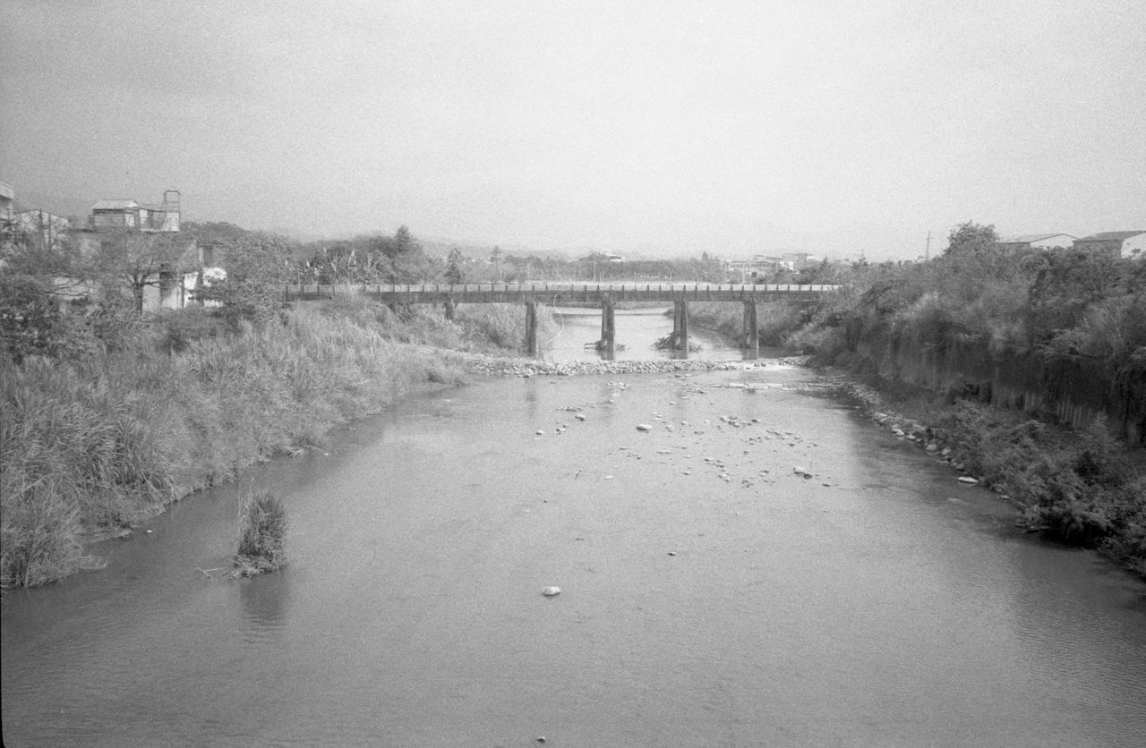 black and white, water, monochrome, monochrome photography, nature, architecture, sky, built structure, tree, plant, river, day, bridge, environment, no people, outdoors, tranquility, scenics - nature, landscape, land, building exterior, reflection, waterway