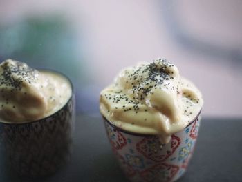 Close-up of ice cream in cups on table