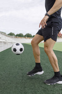 Man playing with soccer ball on field