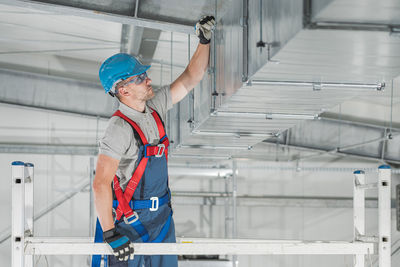 Low angle view of worker working in factory