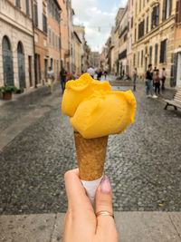 Gelato ice cream in women's hand in rome, italy