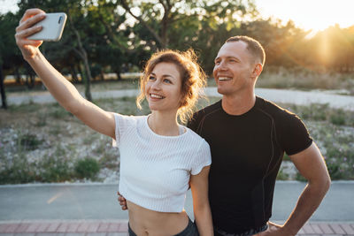 Smiling young woman using mobile phone