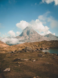 Scenic view of mountains against cloudy sky