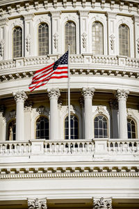 Flag waving on historical building in city