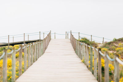 Wooden railing against clear sky