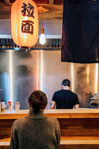 Rear view of people sitting at restaurant