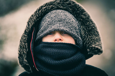 Close-up portrait of girl wearing warm clothing