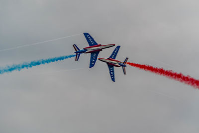 Low angle view of airplane flying against sky