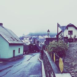 Houses in town against clear sky