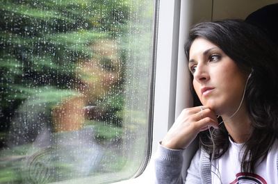 Woman looking through train window