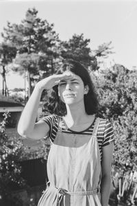 Portrait of woman standing against plants